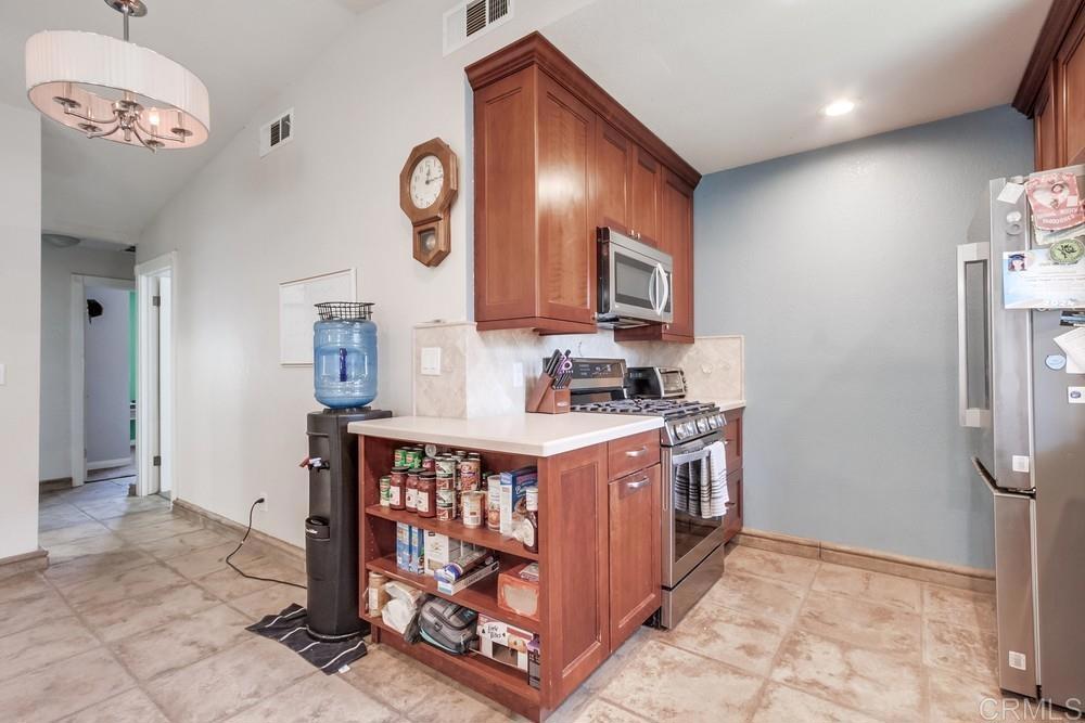 415 3rd Street Ramona, CA 92065 - Photo 12 of 33 a kitchen with stainless steel appliances granite countertop a stove a refrigerator and a cabinets