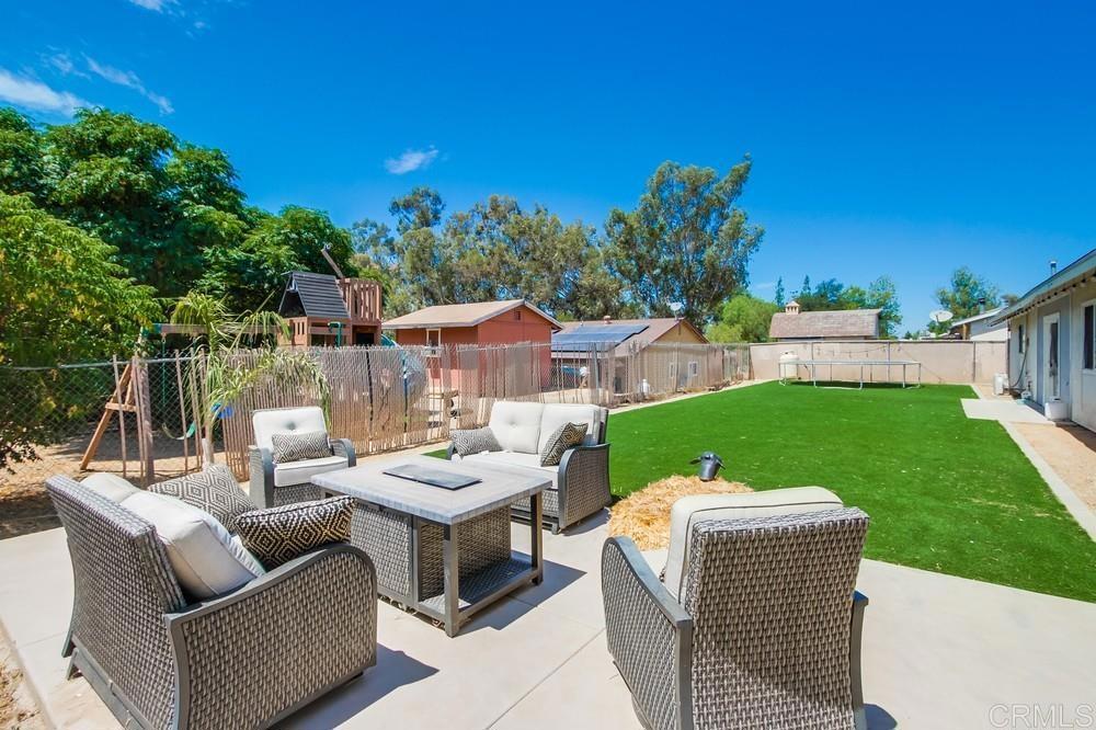 415 3rd Street Ramona, CA 92065 - Photo 27 of 33 a view of a patio with couches chairs and a table and potted plants