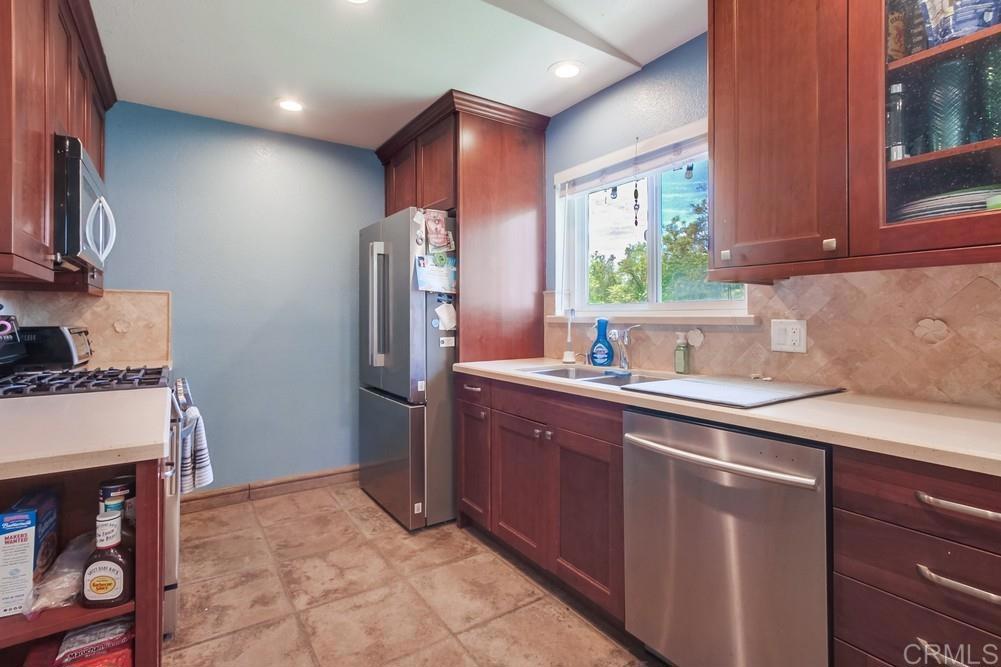 415 3rd Street Ramona, CA 92065 - Photo 9 of 33 a kitchen with stainless steel appliances granite countertop a refrigerator and sink
