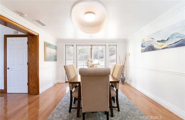 a dining room with furniture and a window