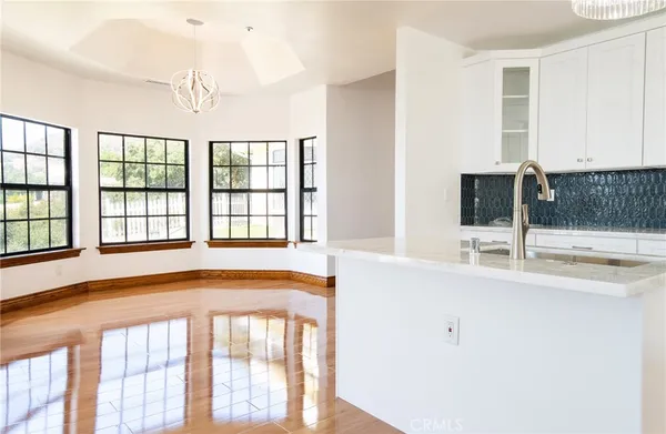 a living room with furniture dining table a fireplace and a flat screen tv