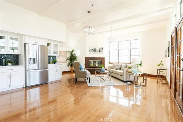 a living room with furniture large window and a fireplace