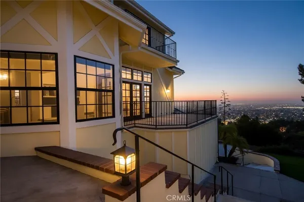 a view of a house with a yard and patio
