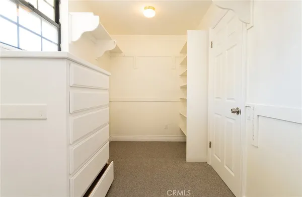 an empty room with a chandelier fan