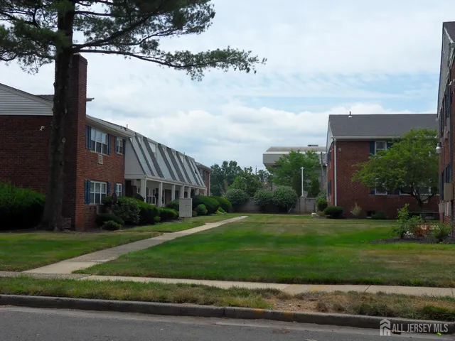 a view of a big building next to a yard