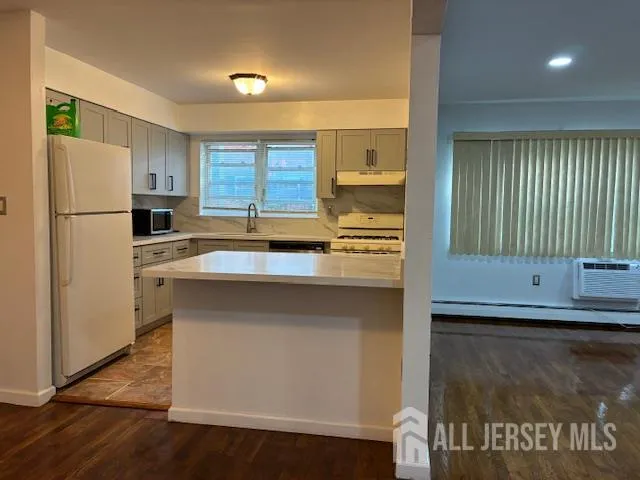 a kitchen with a refrigerator and a sink