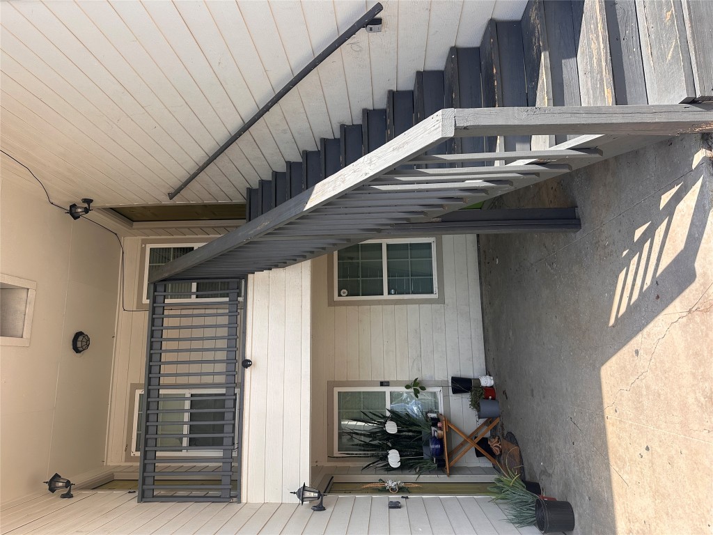 6110 Wheless Cove, Unit F Austin, TX 78723 - Photo 1 of 1 a view of staircase with lots of furniture and white walls