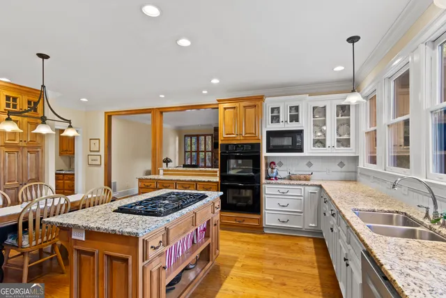 a kitchen with a stove a sink and a refrigerator