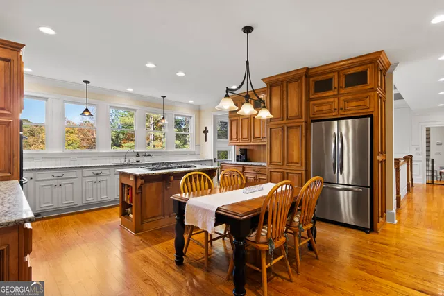 a view of a kitchen with a table and chairs