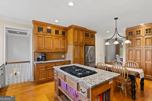 a kitchen that has a stove and a table in it