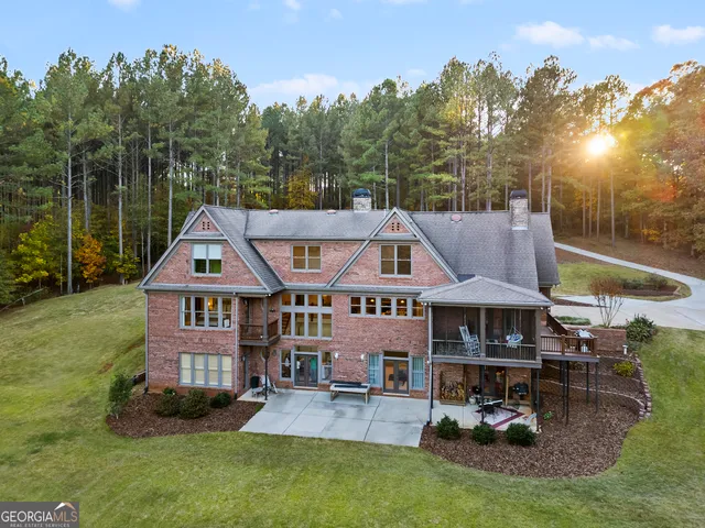 a aerial view of a house with table and chairs under an umbrella