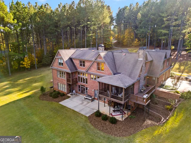 a view of a house with pool and chairs