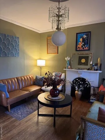 a living room with furniture a chandelier and a rug