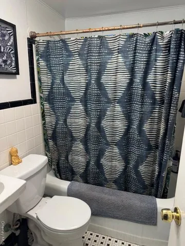 a bathroom with a toilet and shower