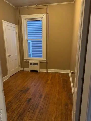 a view of front door with wooden floor