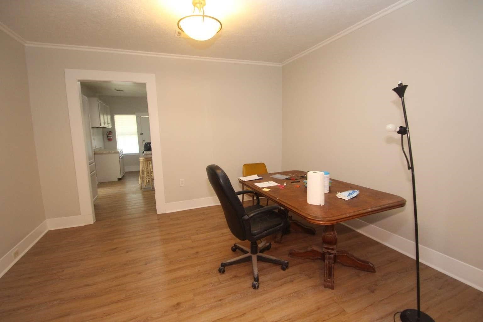 422 Tennessee Street Houston, TX 77029 - Photo 2 of 8 a view of a workspace with furniture and wooden floor
