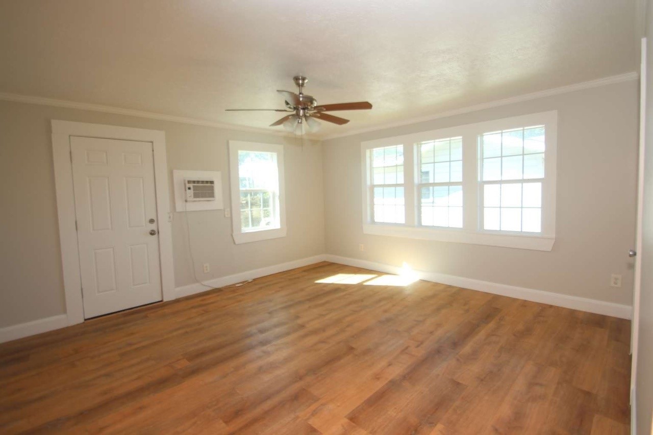 422 Tennessee Street Houston, TX 77029 - Photo 7 of 8 a view of empty room with wooden floor and fan