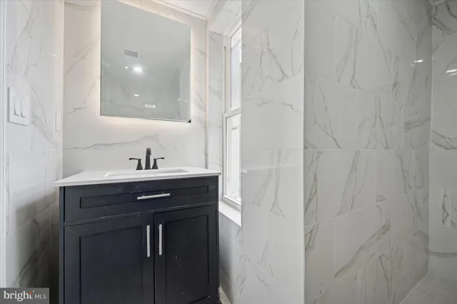 a bathroom with a sink and mirror