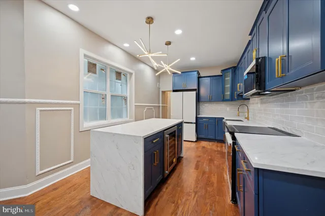 a kitchen with stainless steel appliances granite countertop a sink a stove and a refrigerator