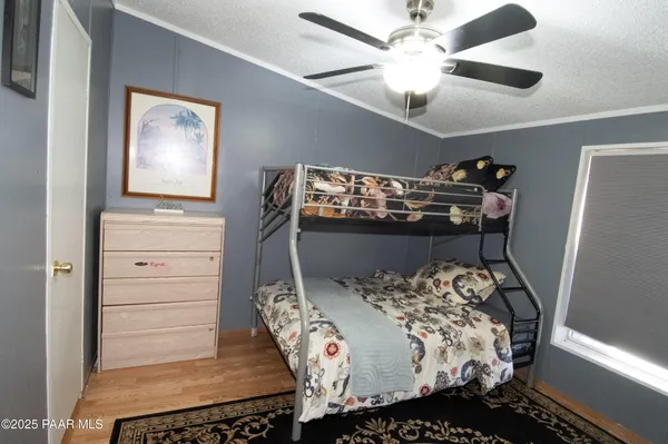a bedroom with a bed and a ceiling fan