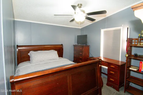 a bedroom with bed and wooden floor