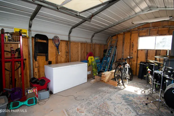 a view of a garage with rack and bicycle