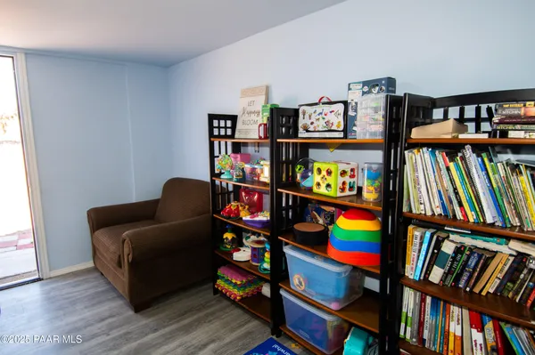 a living room with lots of books and a book shelf