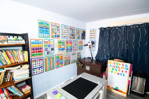 a view of a workspace with furniture and toys