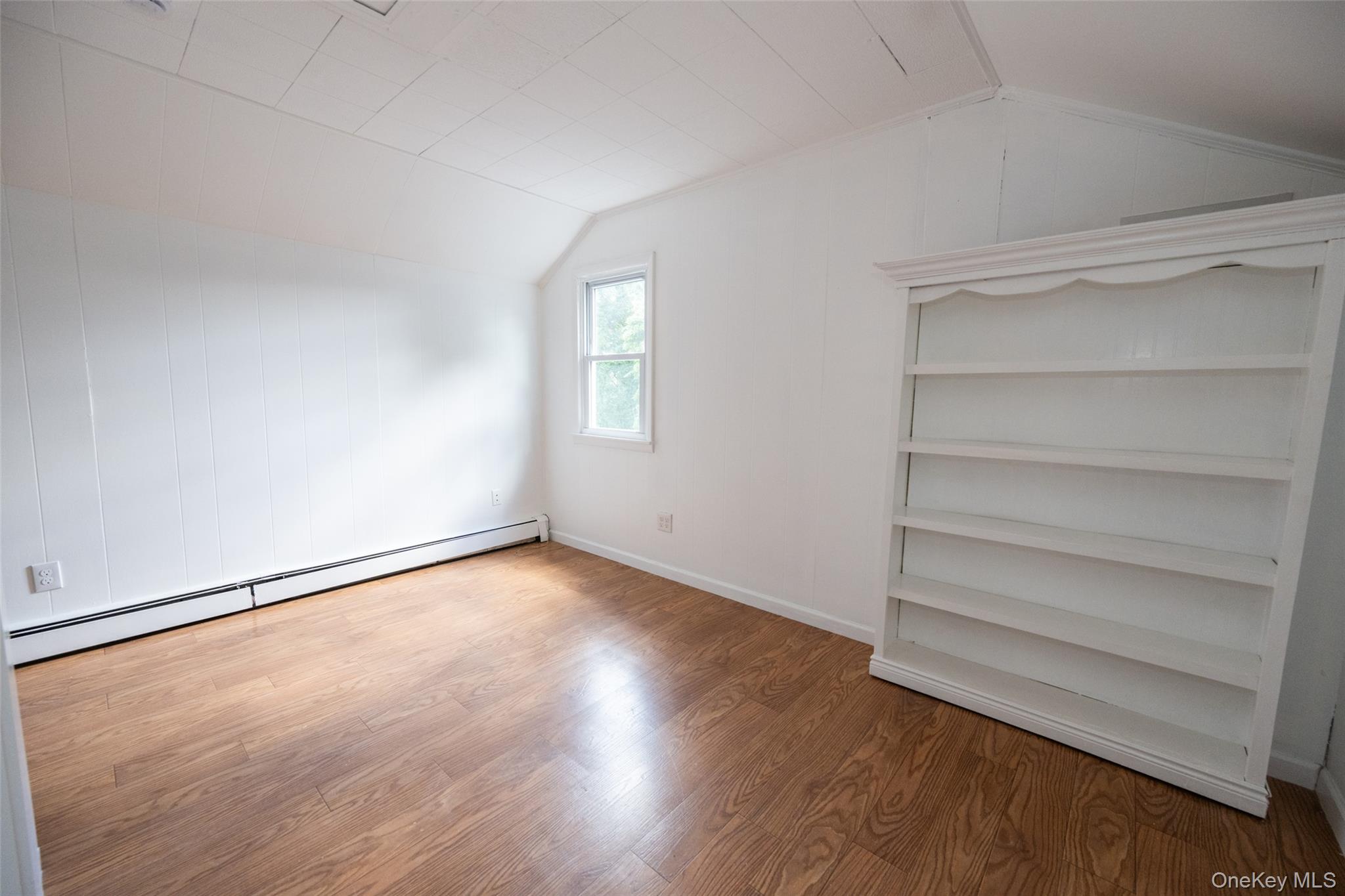 136 Foggintown Road Brewster, NY 10509 - Photo 33 of 50 a view of an empty room with a window and wooden floor