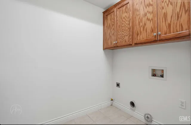 a view of a microwave and cabinets