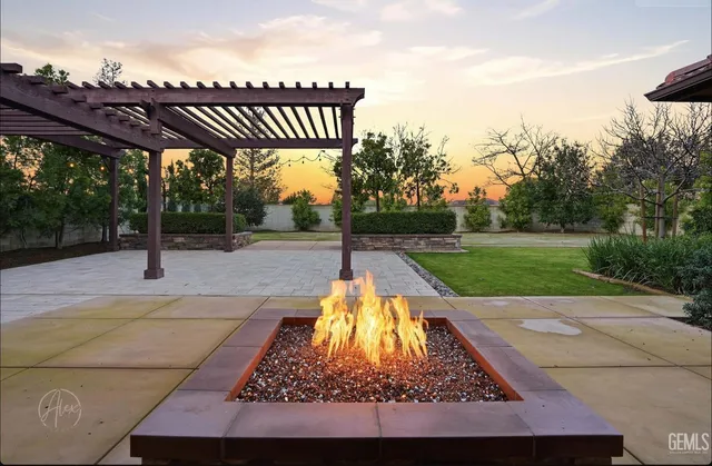 a view of a backyard with a table and chairs