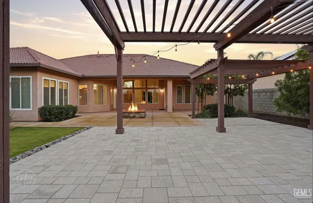 a view of a porch with a table and chairs