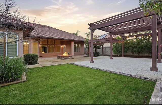 a backyard of a house with table and chairs