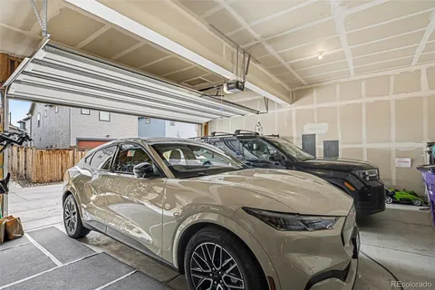 a utility room with a washing machine and a rug