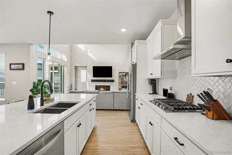 a kitchen with stainless steel appliances a sink a stove top oven a counter space and cabinets