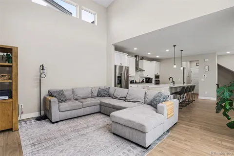 a living room with furniture and kitchen view
