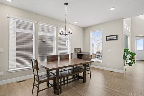 a dining room with furniture and wooden floor