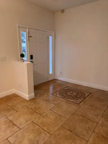 an empty room with wooden floor and cabinet