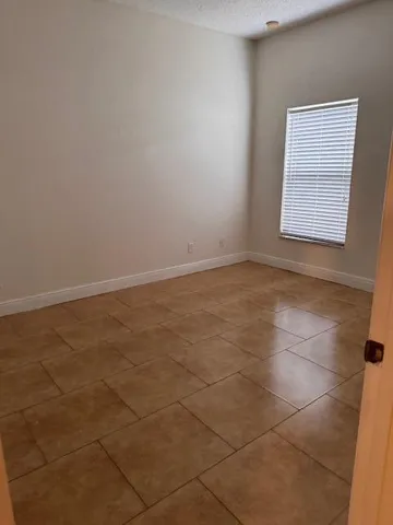 an empty room with white walls and tiles