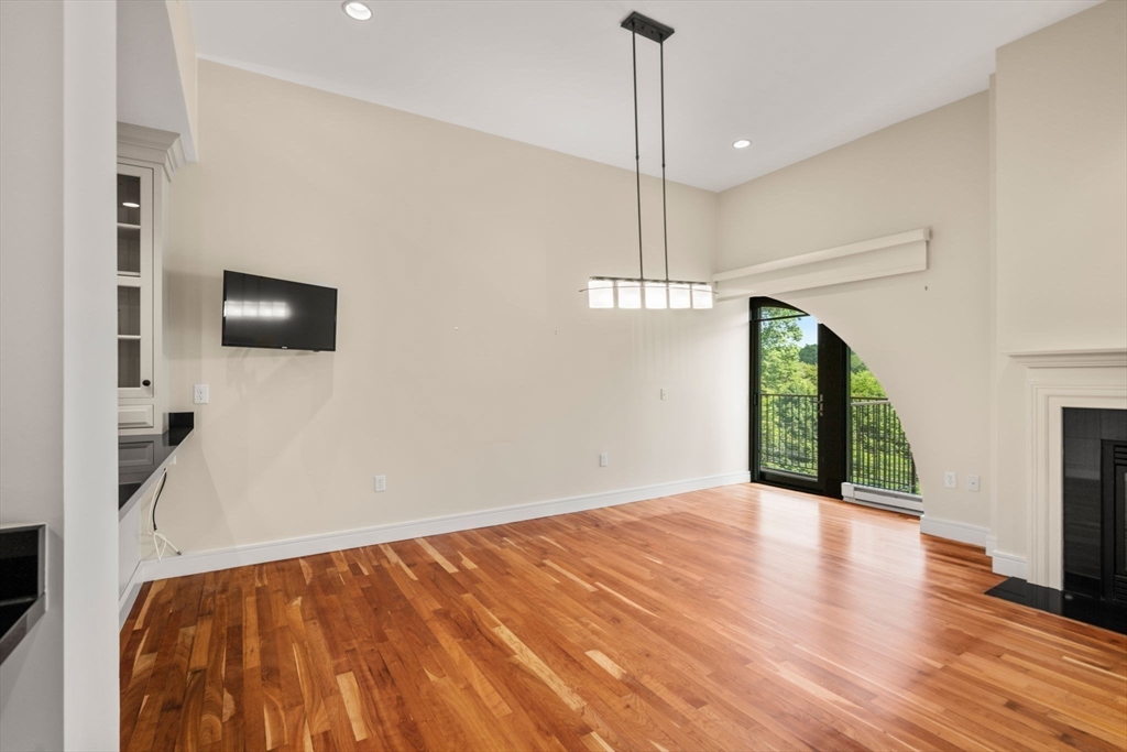 2420 Beacon Street, Unit 402 Boston, MA 02467 - Photo 14 of 29 a view of an empty room with a window and wooden floor