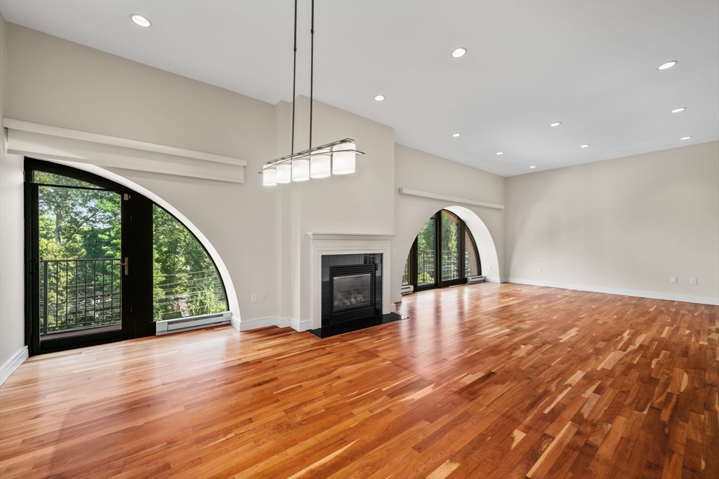2420 Beacon Street, Unit 402 Boston, MA 02467 - Photo 16 of 29 a view of an empty room with wooden floor fireplace and a window