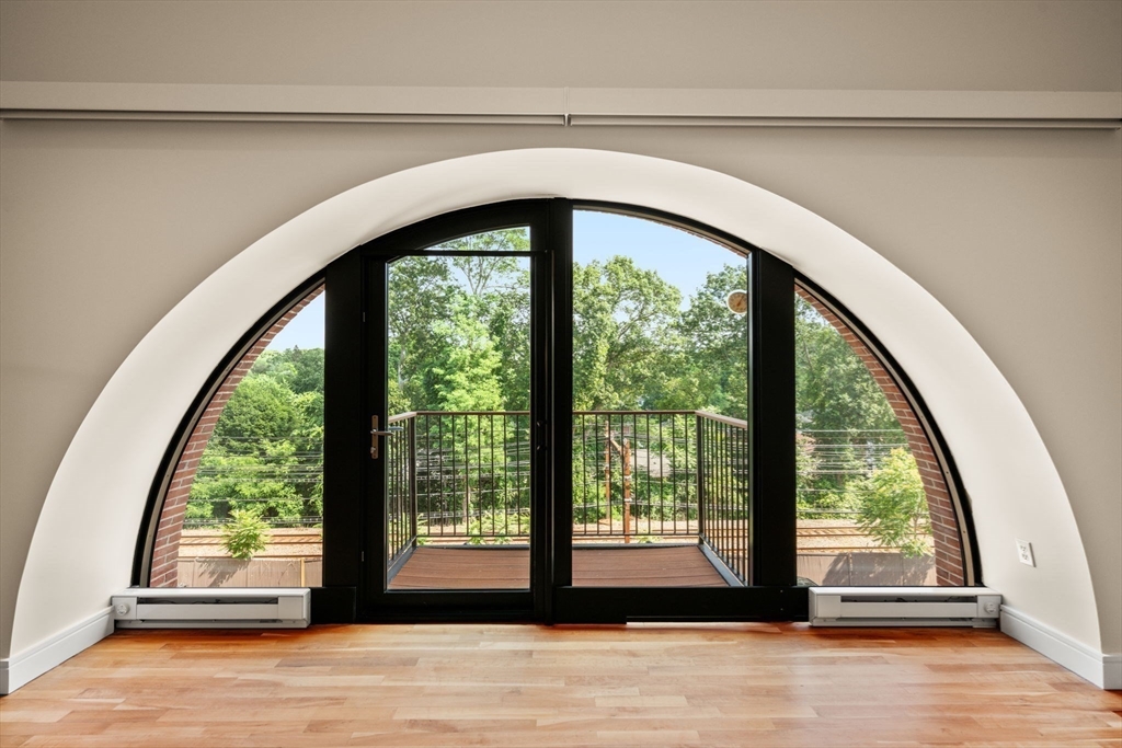 2420 Beacon Street, Unit 402 Boston, MA 02467 - Photo 17 of 29 a view of empty room with wooden floor and a large window