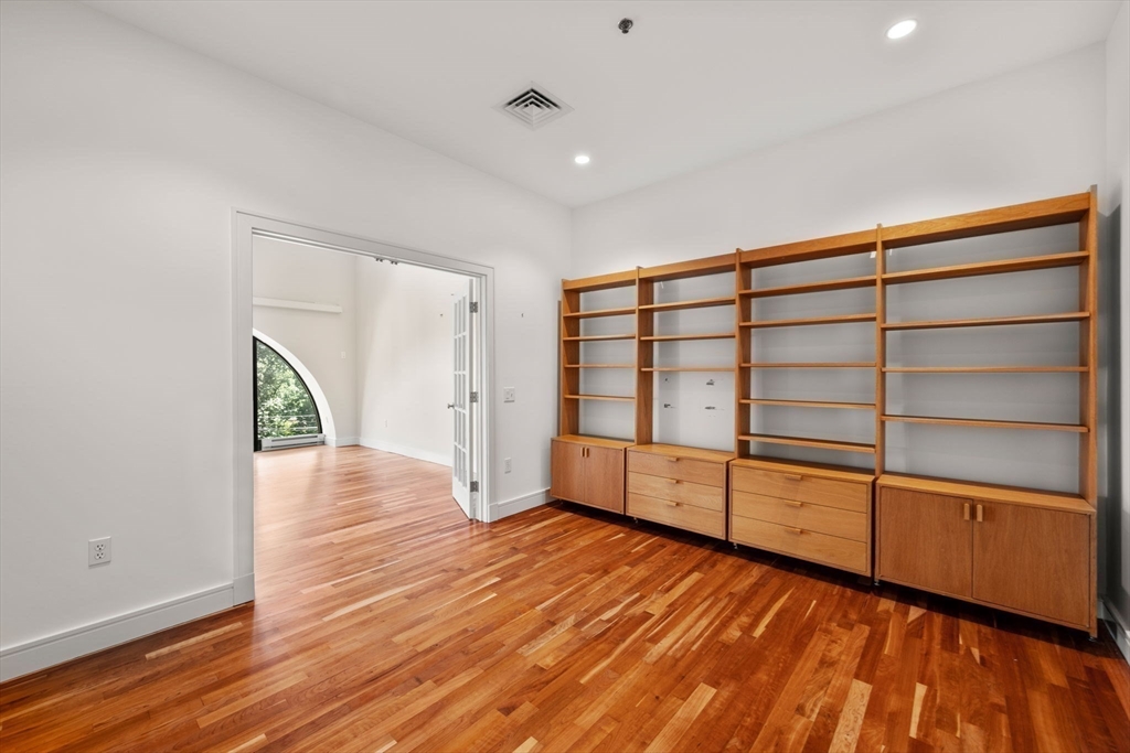 2420 Beacon Street, Unit 402 Boston, MA 02467 - Photo 20 of 29 a view of an empty room with wooden floor and windows