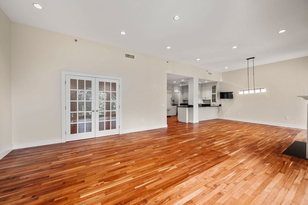 2420 Beacon Street, Unit 402 Boston, MA 02467 - Photo 22 of 29 a view of empty room with wooden floor and windows
