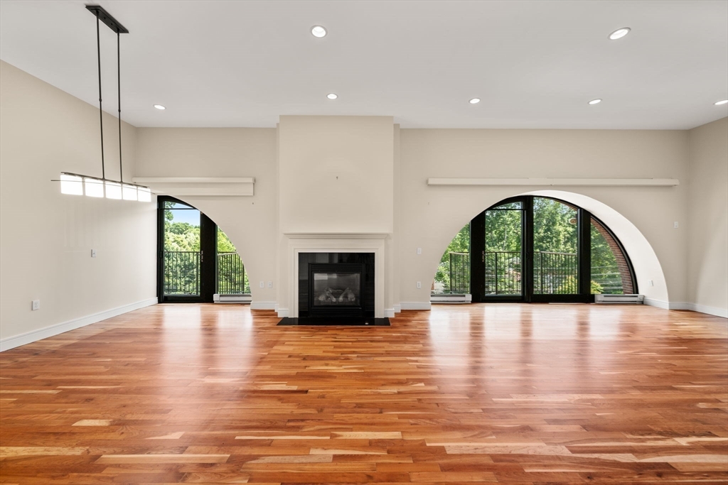 2420 Beacon Street, Unit 402 Boston, MA 02467 - Photo 24 of 29 a view of an empty room with a fireplace and a window