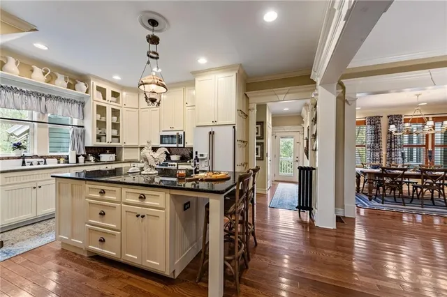 a kitchen with stainless steel appliances sink stove and cabinets