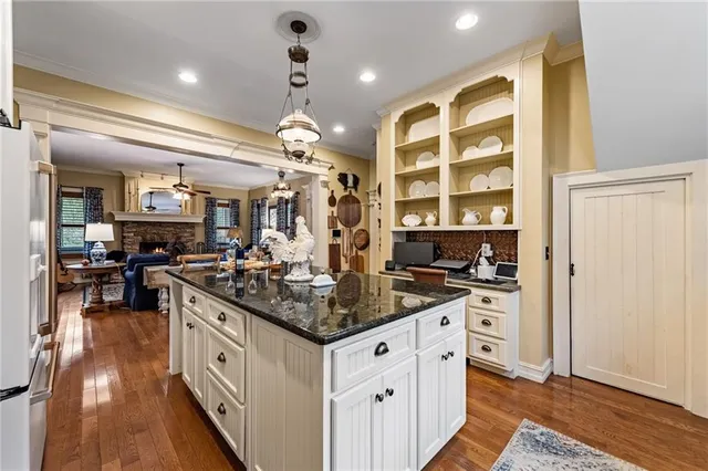 a kitchen with stove and refrigerator