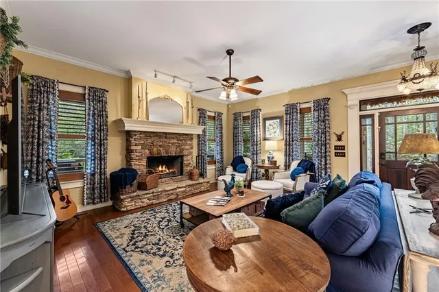 a living room with furniture a fireplace and a chandelier