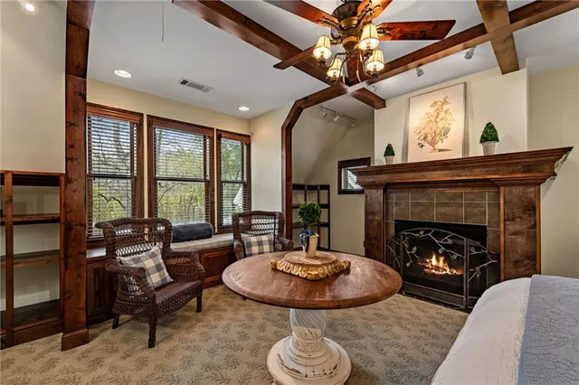 a living room with furniture a ceiling fan and a rug