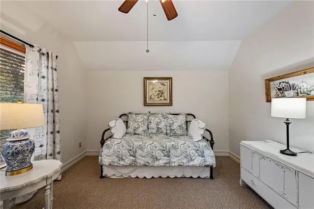 a view of a backyard with a slide trees and wooden fence